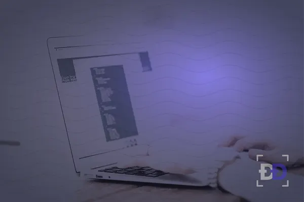 Hands type on a laptop showing code in an editor.